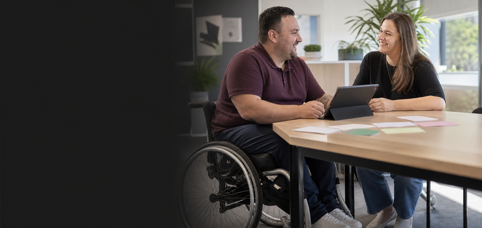 An adult NDIS participant reviewing support choices with a support coordinator